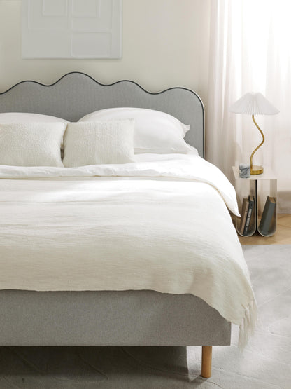 Romy Upholstered Bed with Wavy Headboard