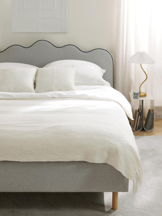 Romy Upholstered Bed with Wavy Headboard